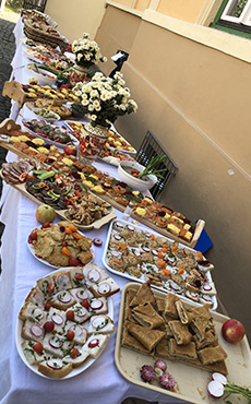 Tables placed outside and filled with many types of traditional Romanian foods