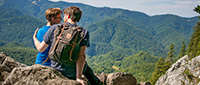 Tourists hiking in the Romanian mountains and enjoying the panoramic views