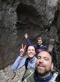 Happy tourists hiking through a canyon in Romania